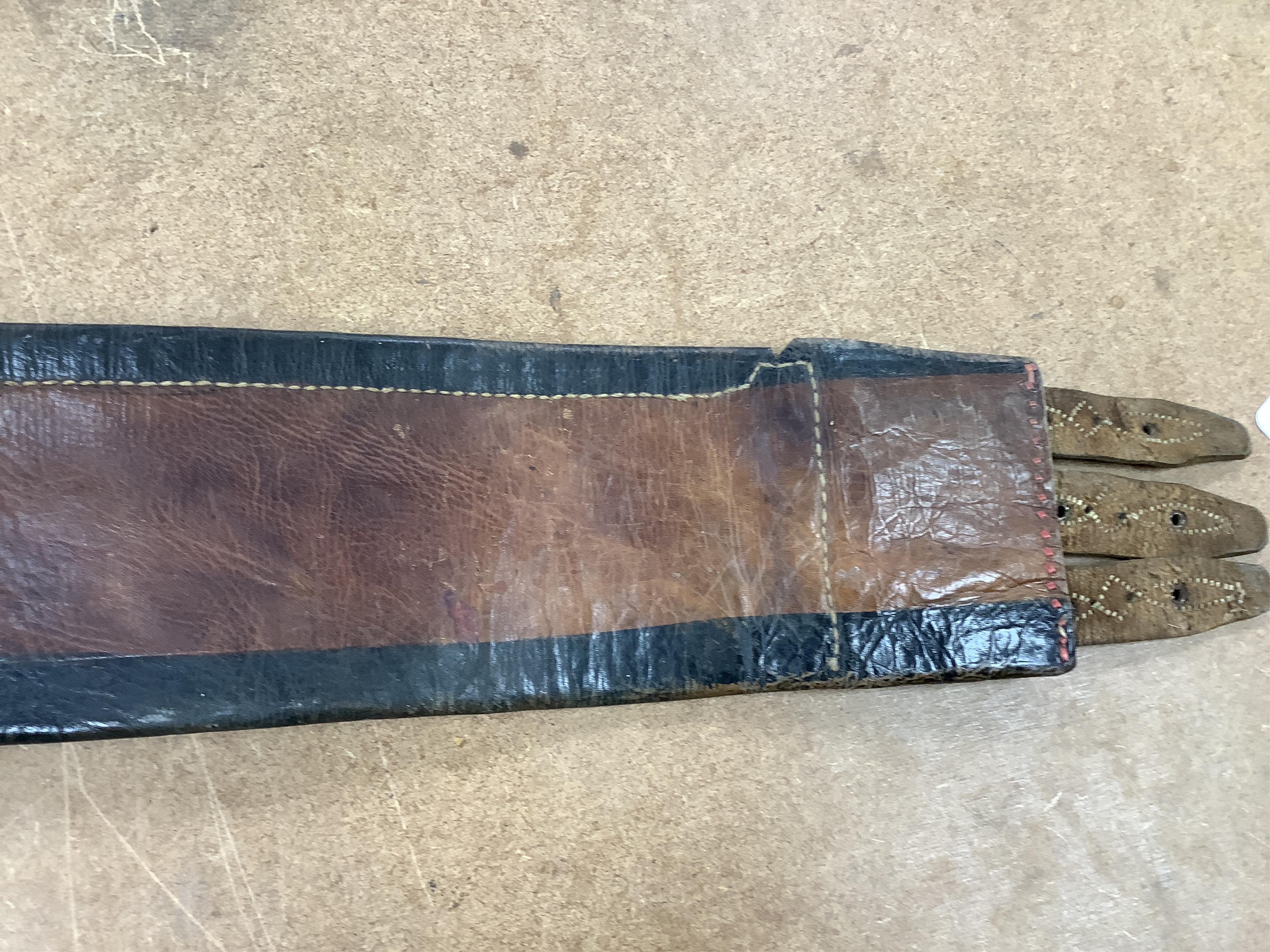 An Argentinian braided leather belt and whips, one with mother of pearl inlay